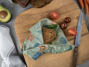 Honeywrap - Reusable Food Wrap. Ocean Design Wrapping a Sandwich.